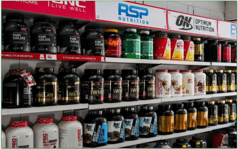 Tubs of different protein powders on a shelf