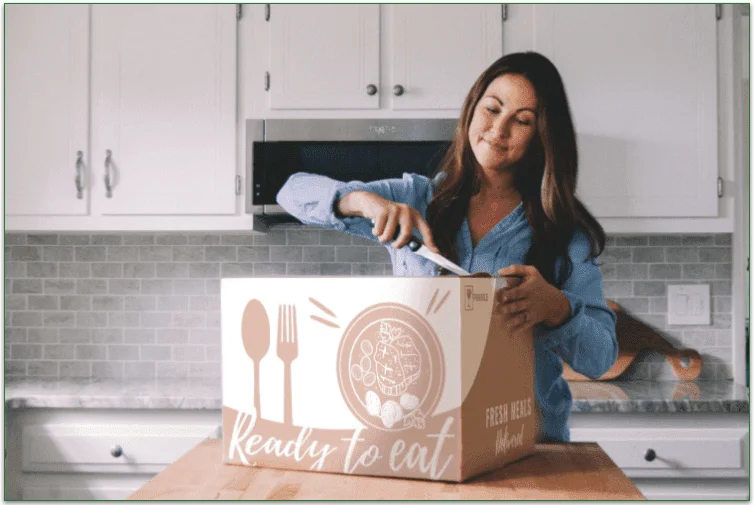 Woman opening a delivery box