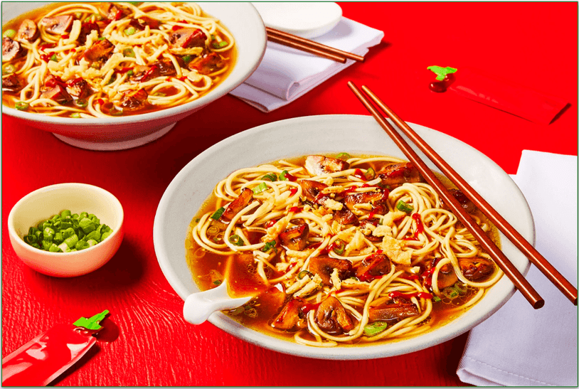 Stock photo of HelloFresh's vegan Mushroom and Soy Ramen served in two bowls with chopsticks