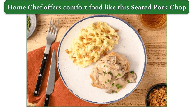 A pork chop with gravy and mashed potatoes