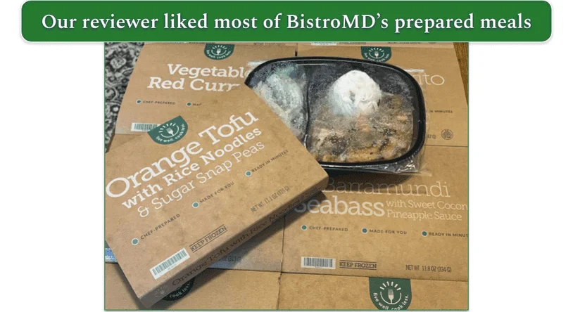 Spread of BistroMD meals in their trays with Orange Tofu on the top