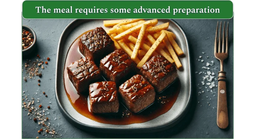 Meat cubes in sauce and French fries served on a plate.