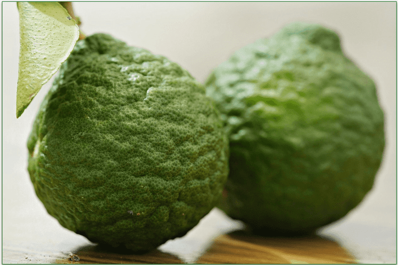 Two makrut limes side by side, one sharp, the other blurred
