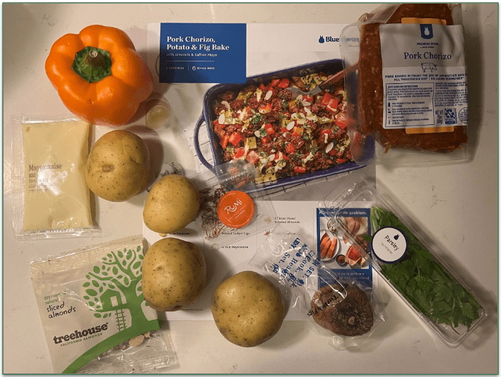 An unboxed meal kit from Blue Apron showing whole vegetables