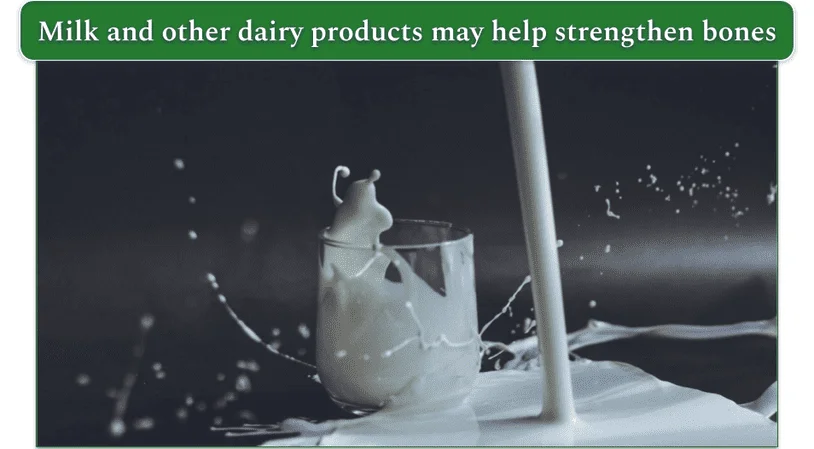 Spilled milk next to a half-full glass of milk, the contents of which are splashing.