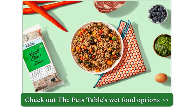Image of The Pets Table's Beef Stew fresh recipe in a bowl surrounded with fresh ingredients and a pack of the recipe