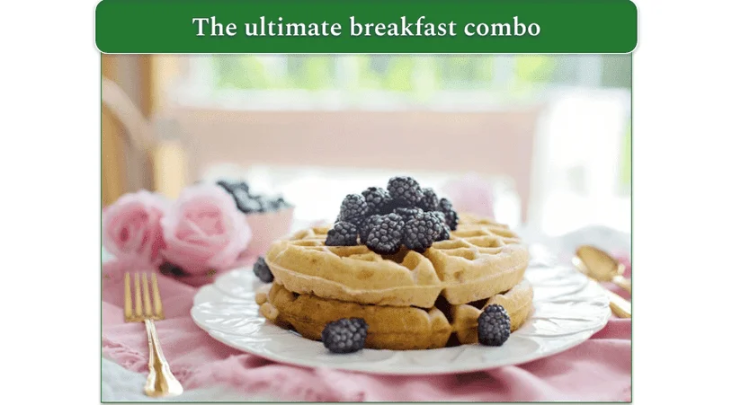 Cinnamon roll waffles on a plate, topped with blackberries.