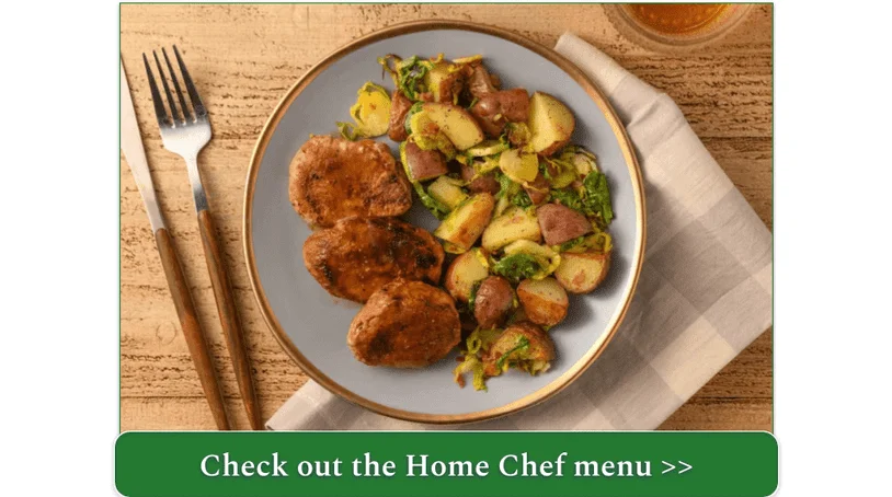 A plate of pork tenderloin beside a side order of roasted  Brussels sprouts and potatoes