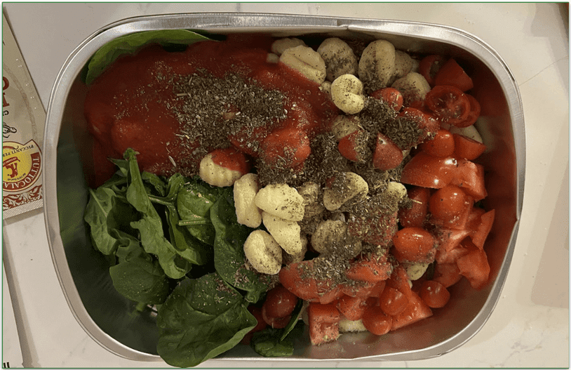 Photo of Blue Apron's Oven-Ready Cheesy Tomato Gnocchi dish with ingredients placed in the oven-ready tray before cooking
