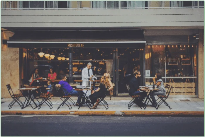 Diners sitting at tables on a restaurant patio
