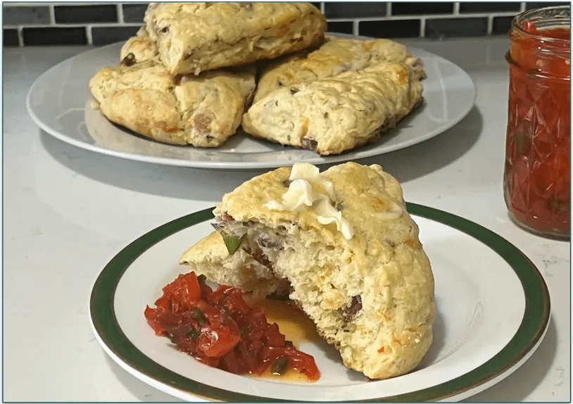 Marley Spoon's Bacon Cheddar Scones served on a plate with butter and pepper jam