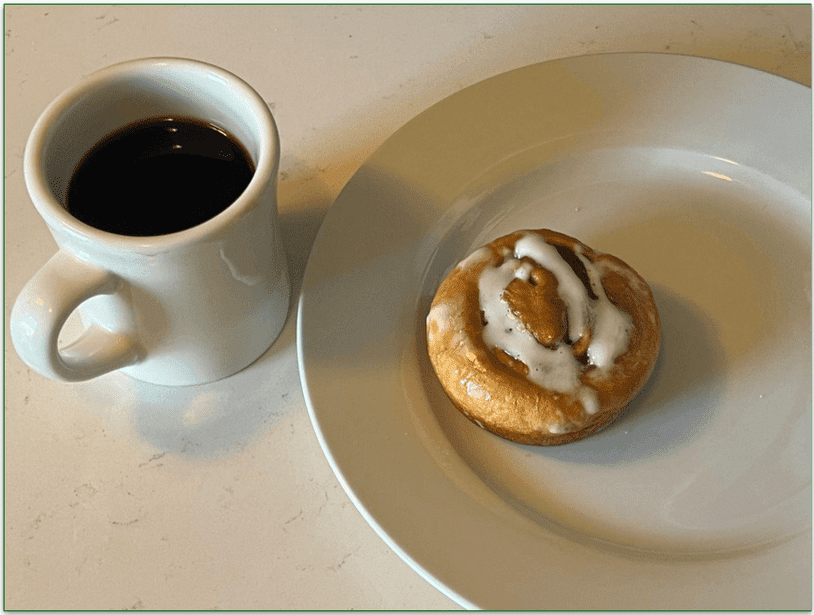 A cinnamon roll from Nutrisystem and a cup of coffee