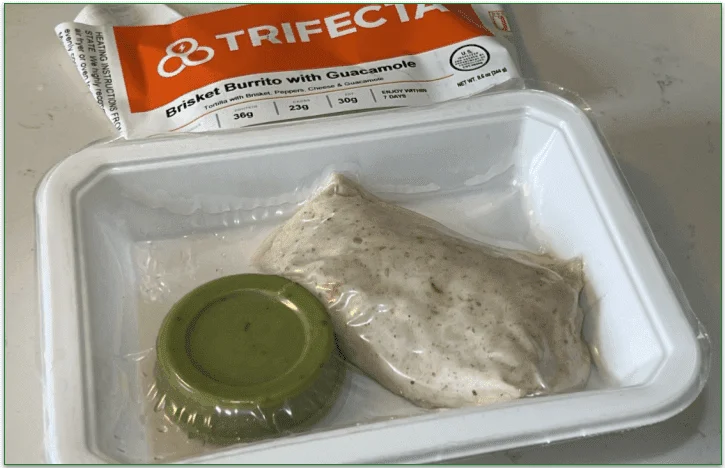 Photo of Trifecta's Brisket Burrito with Guacamole in the vacuum sealed packaging