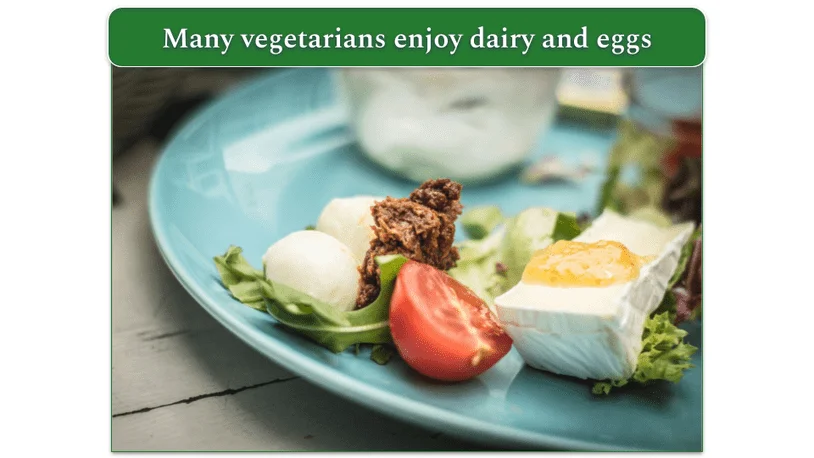 A plate with veggies, eggs, and cheese