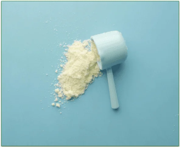 Spilled protein powder next to an empty scoop