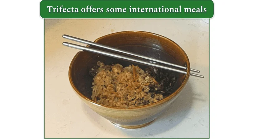 Korean inspired chicken heated up by our reviewer in a bowl with chop sticks