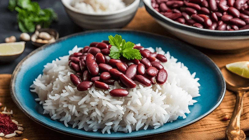 a blue plate of red kidney beans and rice on a wooden table with a piece of fresh coriander on top
