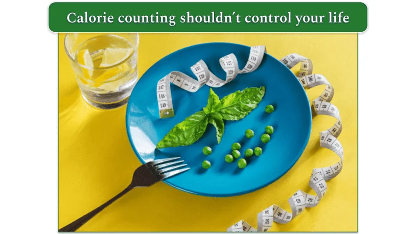A plate with a few peas and herbs on, a glass of water, and a tape measure