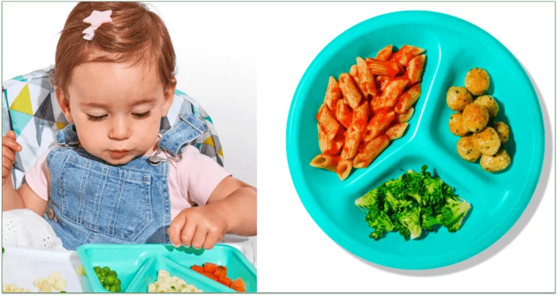 Child eating from a blue plate and a blue plate filled with food