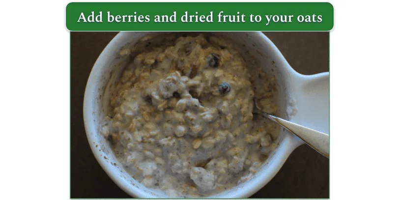 a bowl with oats and berries and milk all mixed together