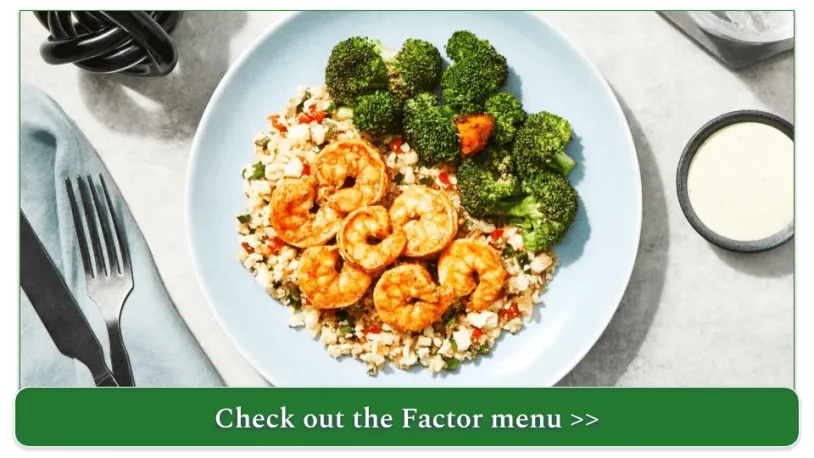 A plate of shrimp with cauliflower rice and broccoli