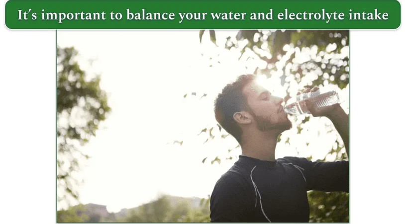 a man drinking water out of a plastic bottle