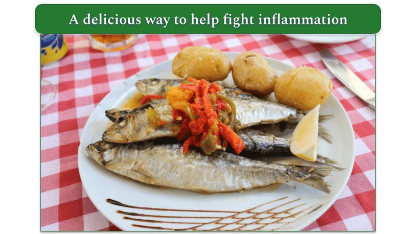 Cooked sardines, potato, and veg served on a plate