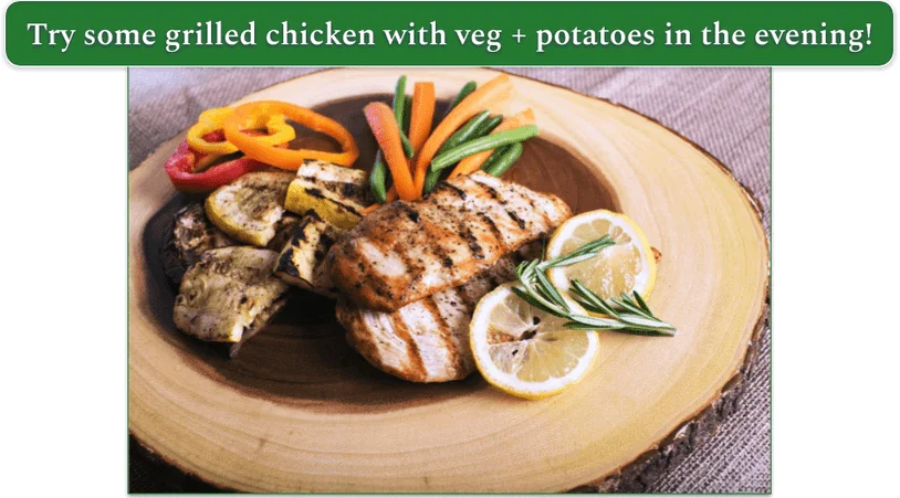 roast chicken on a platter with grilled veg, rosemary, and lemon