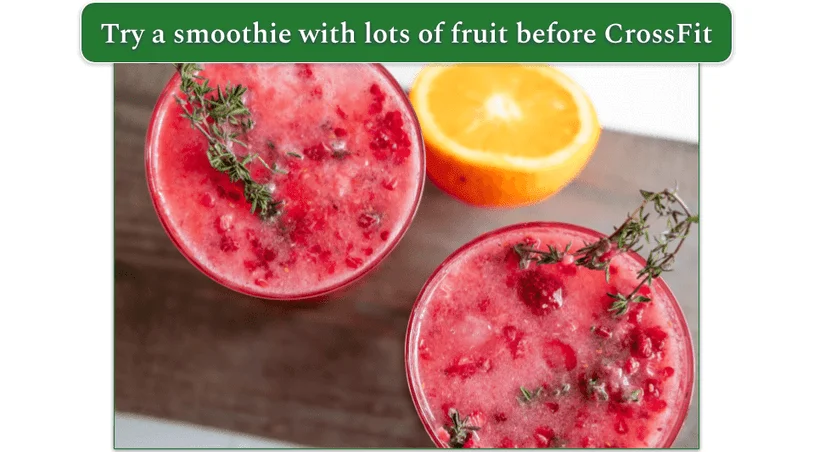 a smoothie with an orange in the background