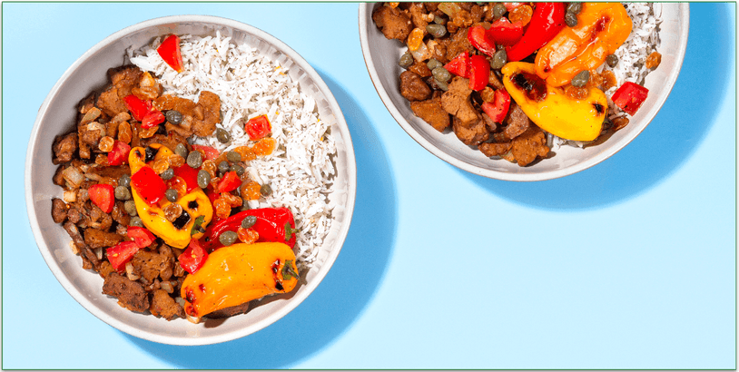 Two bowls of roasted peppers with seitan over rice