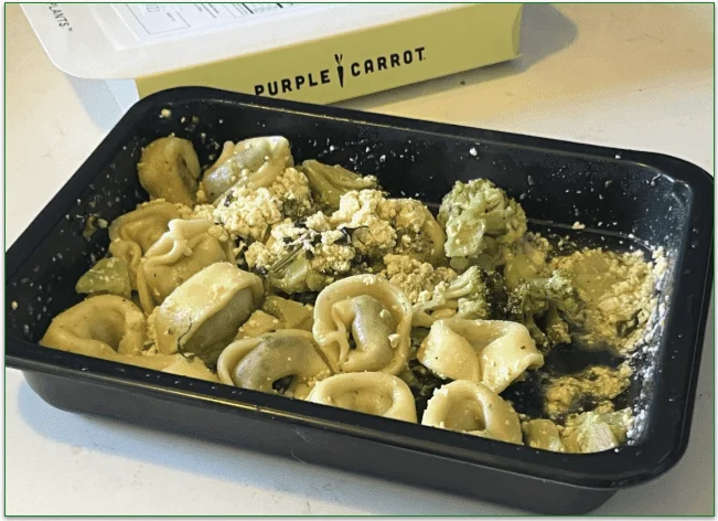 Image of the cooked Pesto Portobello Tortellini in the microwaveable container