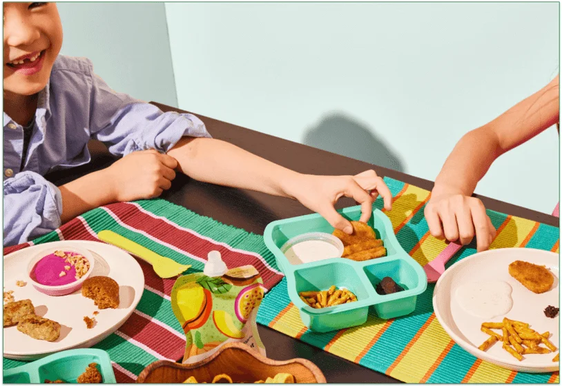 Children eating Little Spoon's meals at a table