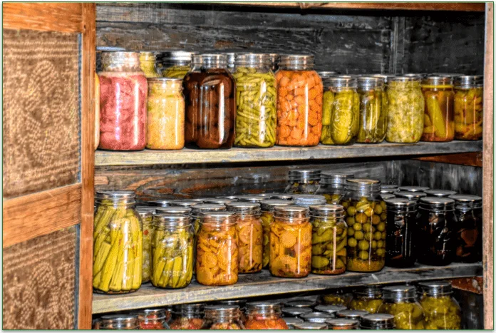 A bunch of jars filled with homemade canned food.