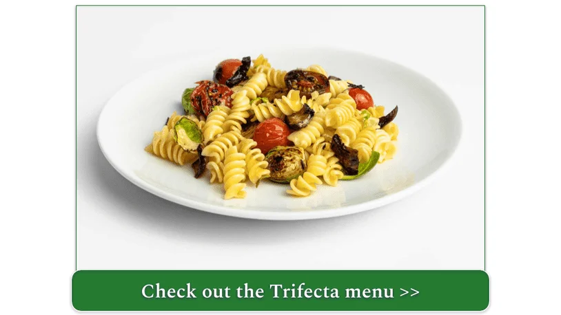 Stock photo of Trifecta's Garlic Pasta with Cherry Tomatoes on a clean plate