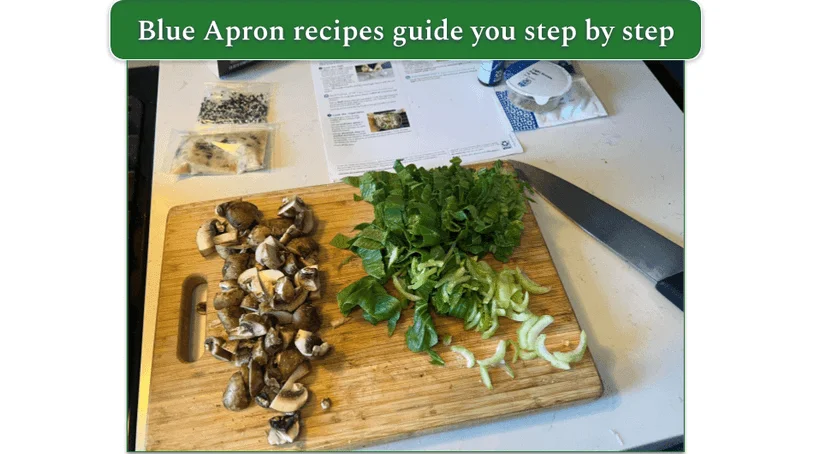 Chopped vegetables on a cutting board next to a Blue Apron recipe card