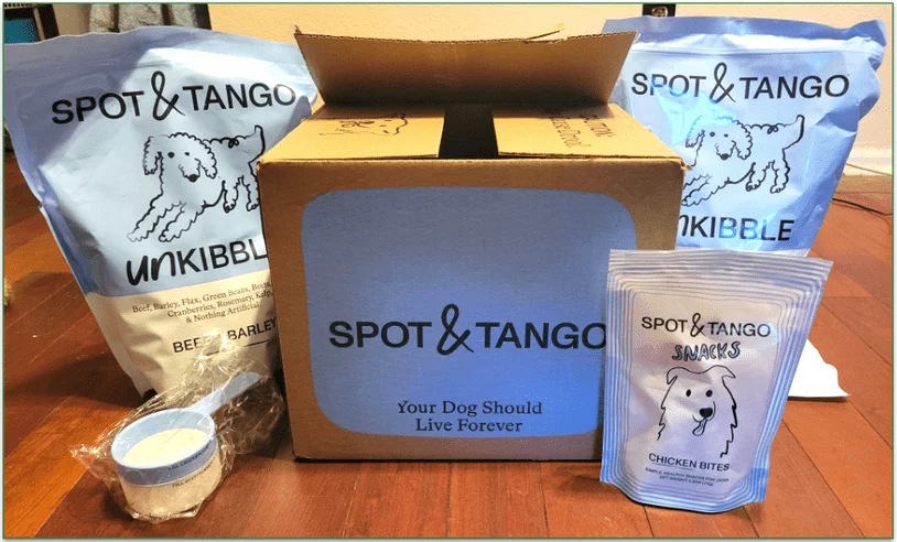 UnKibble bags, treats, and a serving scoop next to Spot & Tango's delivery box