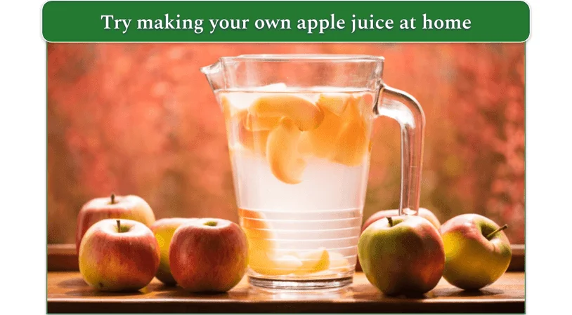 image of whole apples next to a pitcher of apple juice with sliced apple in