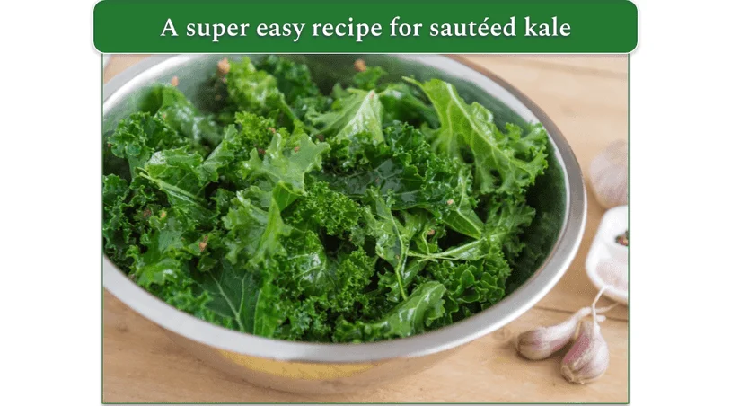 Chopped kale in a bowl next to some cloves of garlic