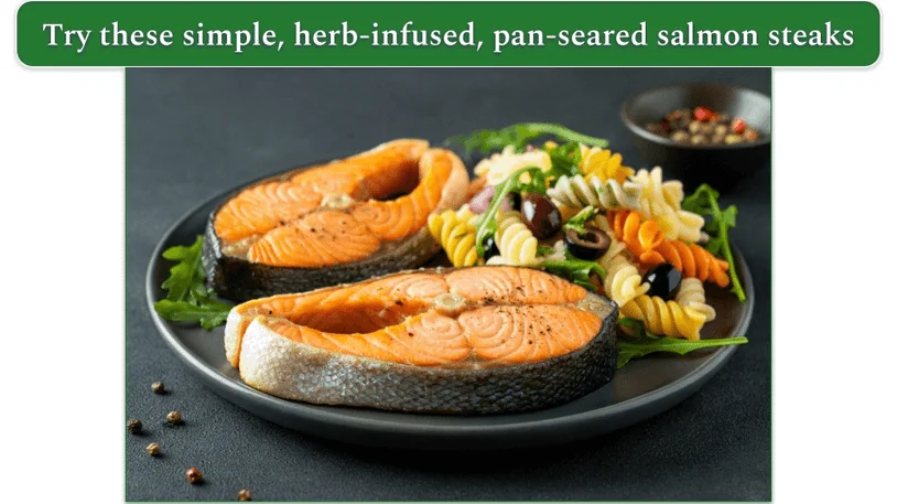 a plate of salmon steaks alongside some pasta salad