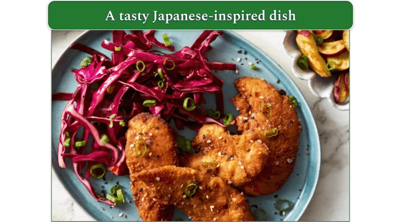 Crispy chicken tenders served with red cabbage slaw and roast potatoes