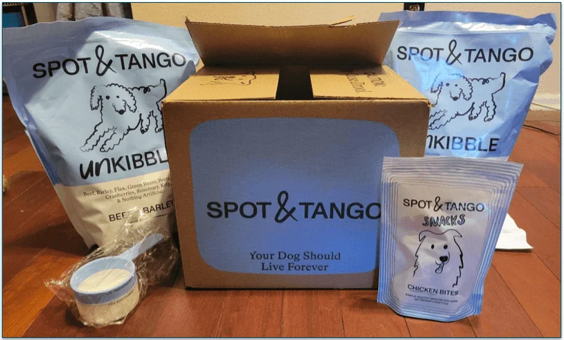 Spot & Tango delivery box with bags of Unkibble, treats, and a serving scoop