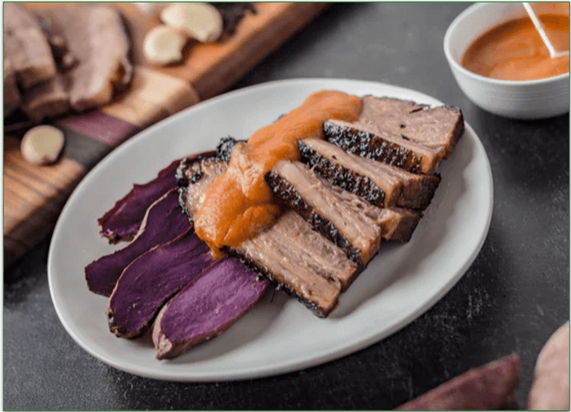 Sliced smoked brisket with sweet potatoes