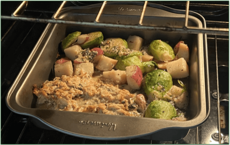Photo of the meal in a metal oven tray being heated in the oven