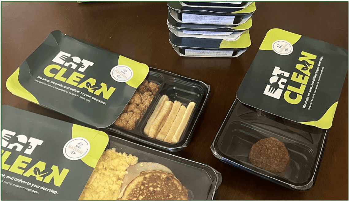 Photo of Eat Clean meals with the cardboard sleeves open to reveal some of the meals in their microwaveable trays