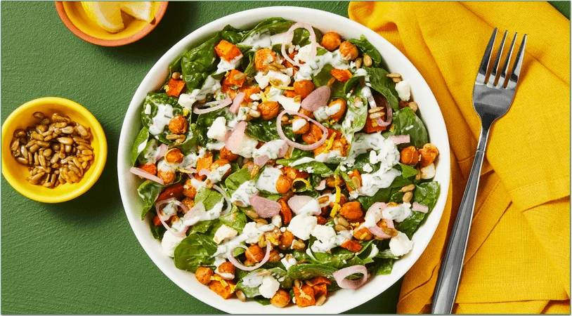 HelloFresh's Harissa Chickpea & Sweet Potato Salad with Feta, Candied Sunflower Seeds, Pickled Shallot & Creamy Lemon Herb Dressing.