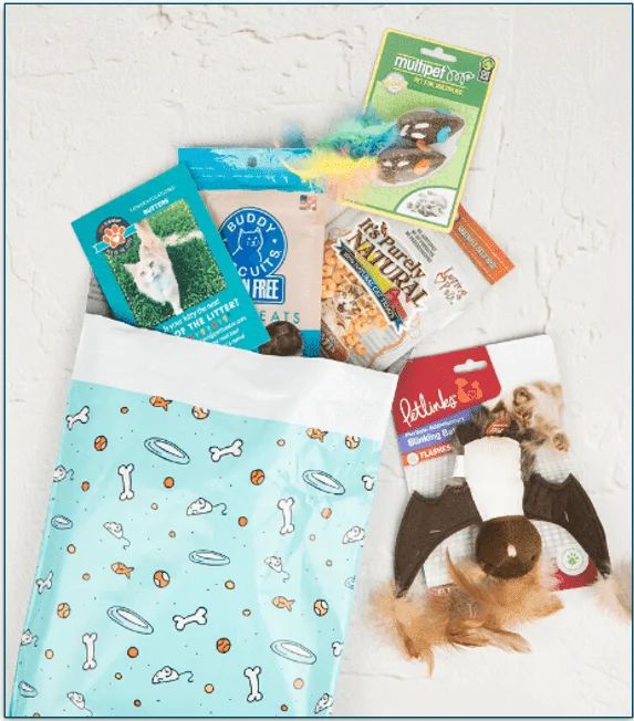 Image of an open Cat Pack with treats and toys