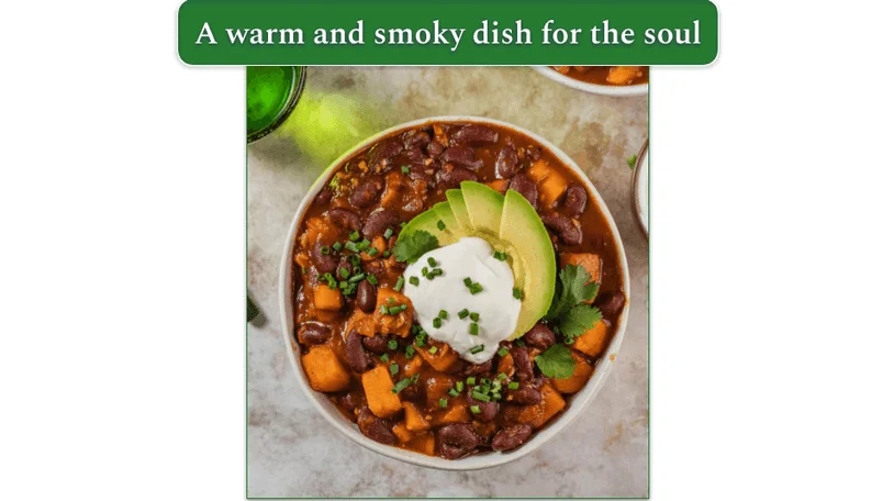Vegetarian Chili in a bowl, served with avocado and sour cream