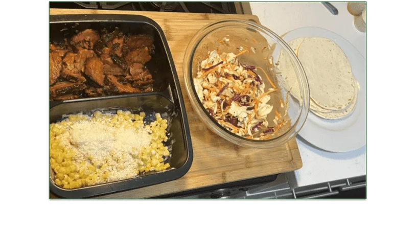 Photo of ingredients set out for tacos including beef, corn, slaw, and tacos