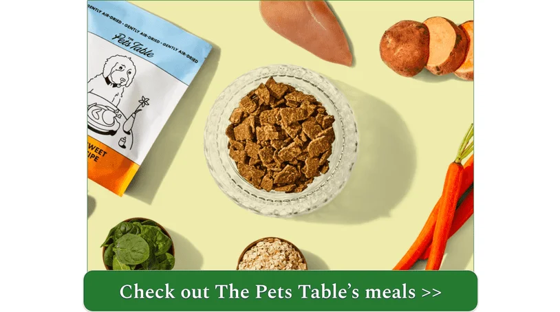 A bowl of The Pets Table's air-dried Chicken & Sweet Potato meal surrounded by its ingredients and packaging