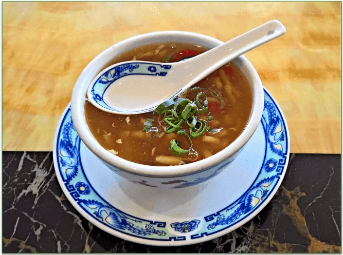 Bowl of miso soup with a serving spoon
